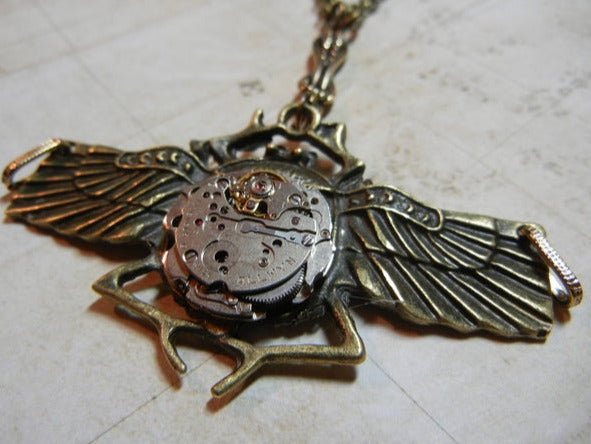 real vintage watch parts adorn the beetle steampunk necklace in bronze