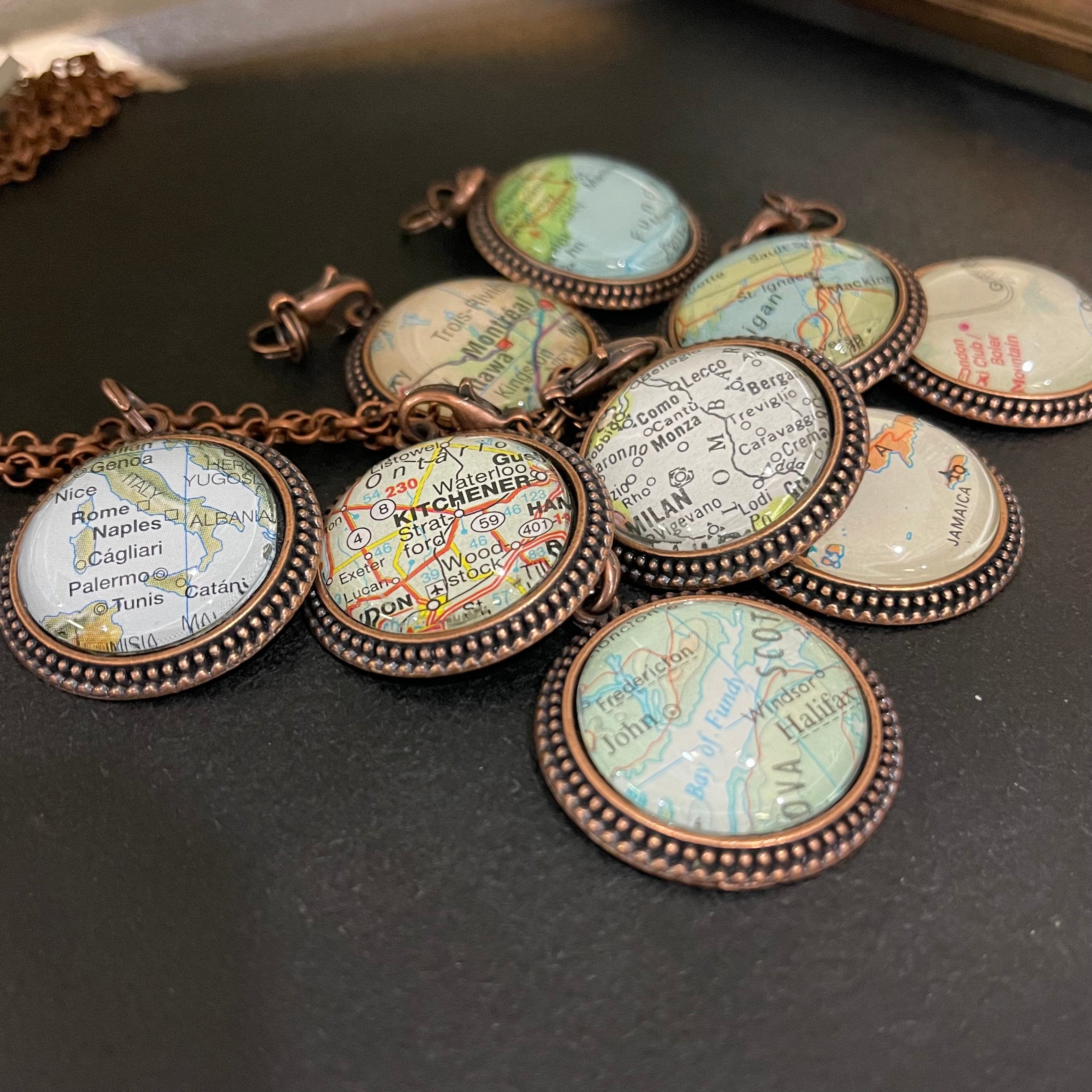 vintage maps used and set under glass to make these handmade custom map necklaces