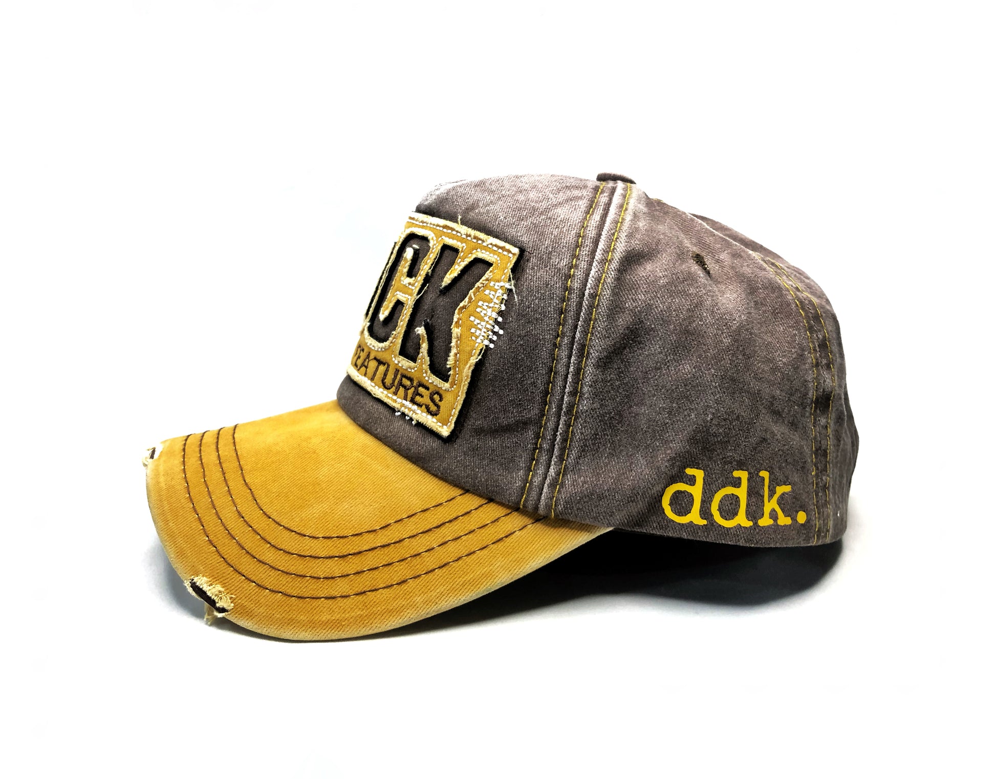 side view of yellow brim ddk rock and roll hat