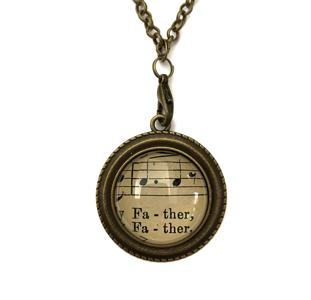 handmade real sheet music form the 1800's vintage necklace sealed under glass cabachon necklace Anthologie