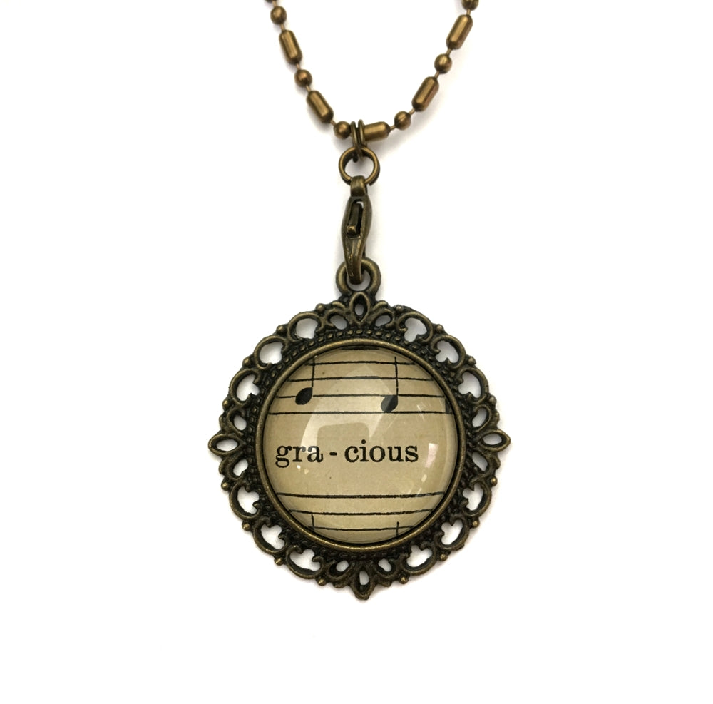 handmade real sheet music form the 1800's vintage necklace sealed under glass cabachon necklace Anthologie